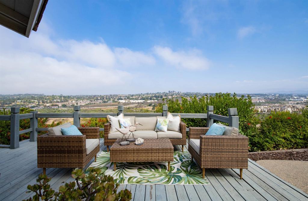 a view of a patio with couches and city view