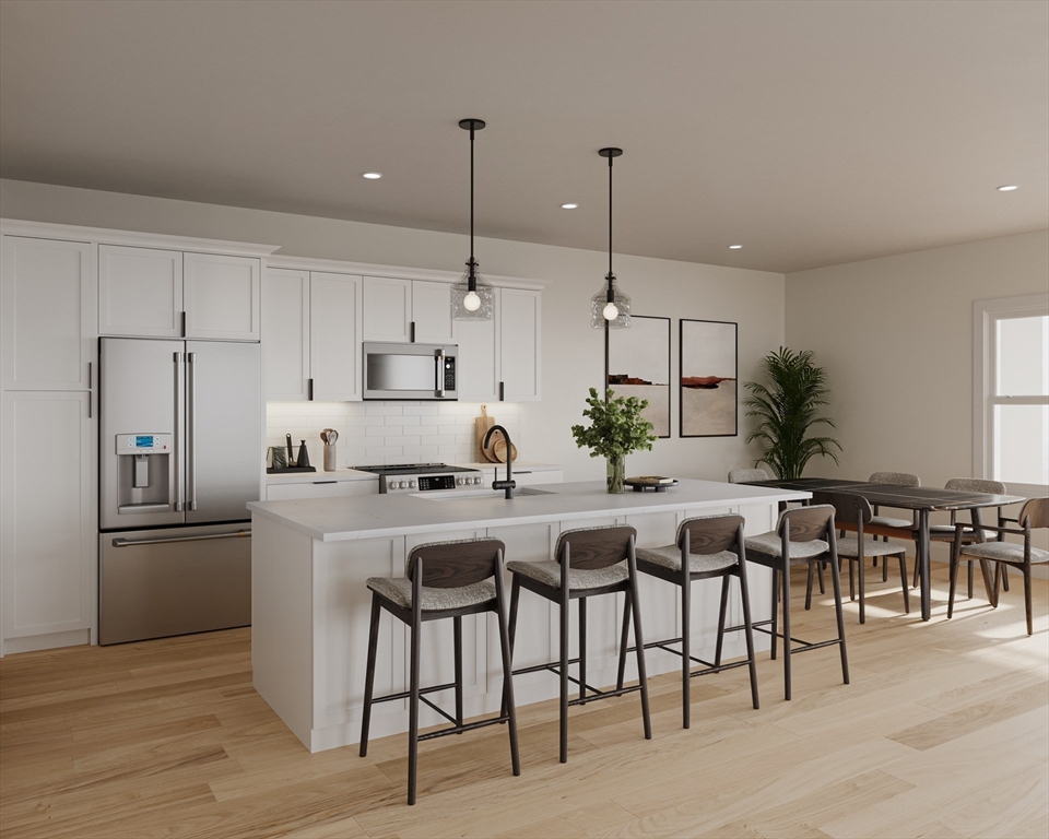 a kitchen with appliances cabinets and wooden floor