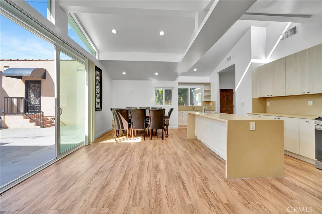 a dining room with furniture and wooden floor