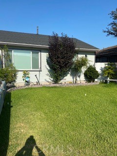 a view of house with backyard