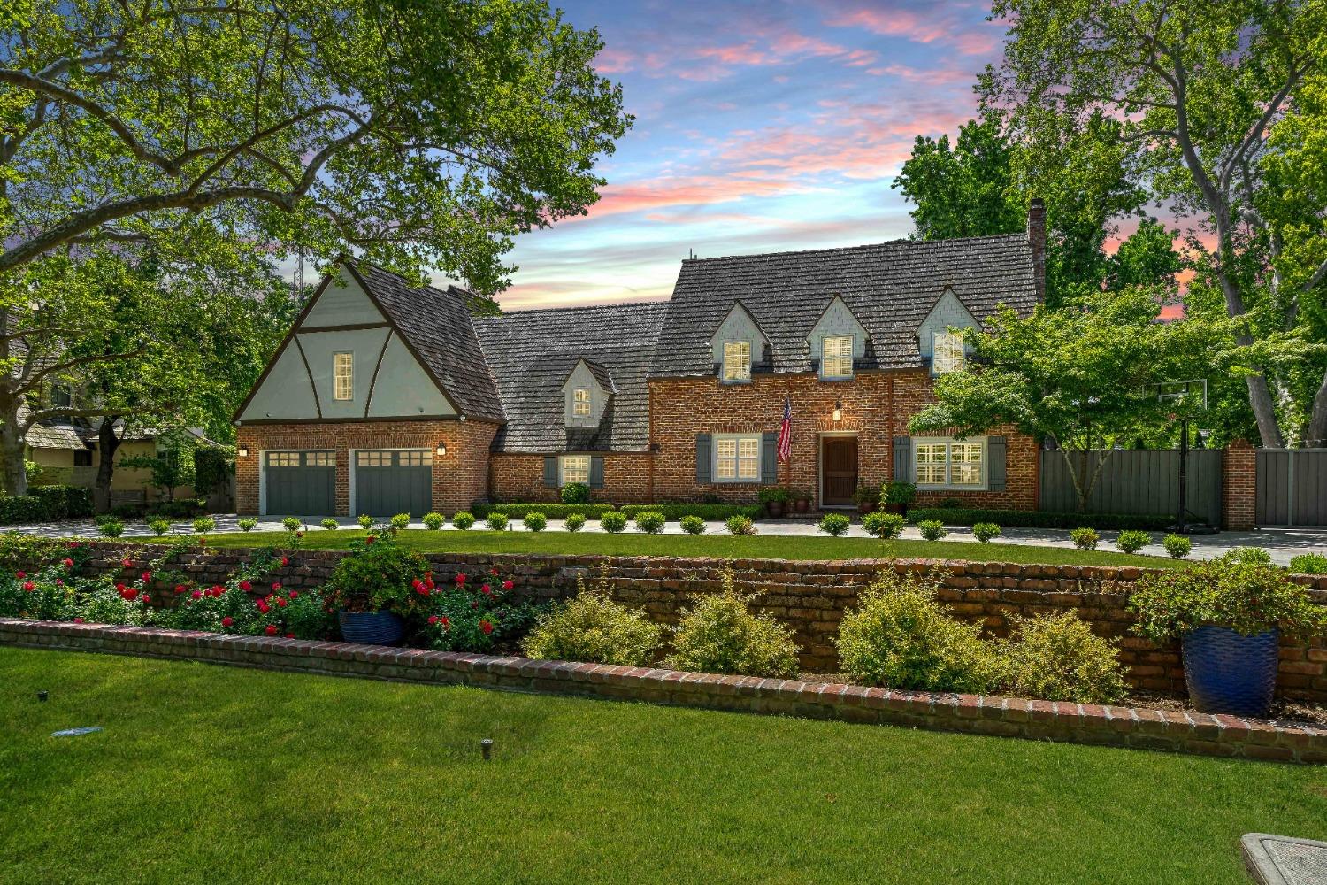 a front view of a house with a garden