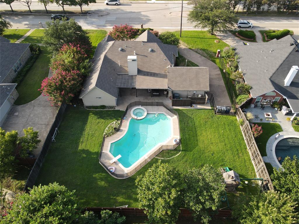 an aerial view of a house with a swimming pool yard and outdoor seating