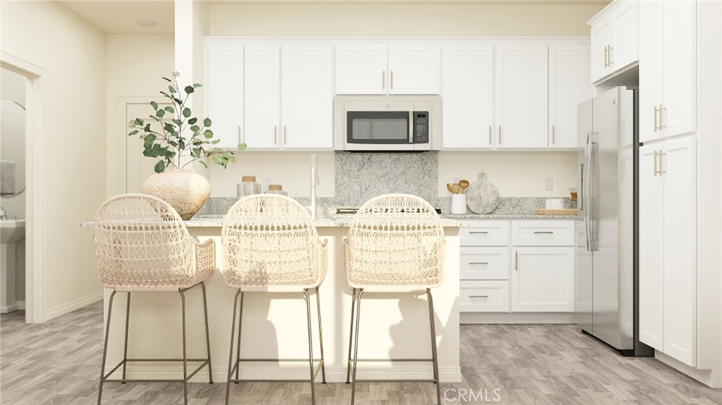 a kitchen with stainless steel appliances white cabinets and a stove