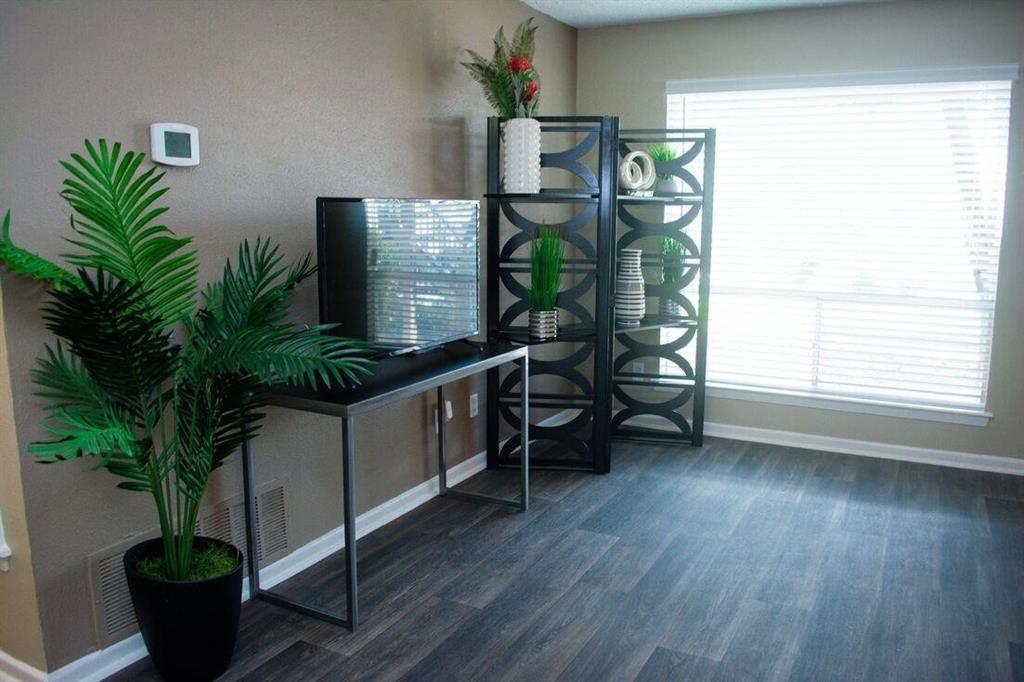 a living room with furniture and a potted plant