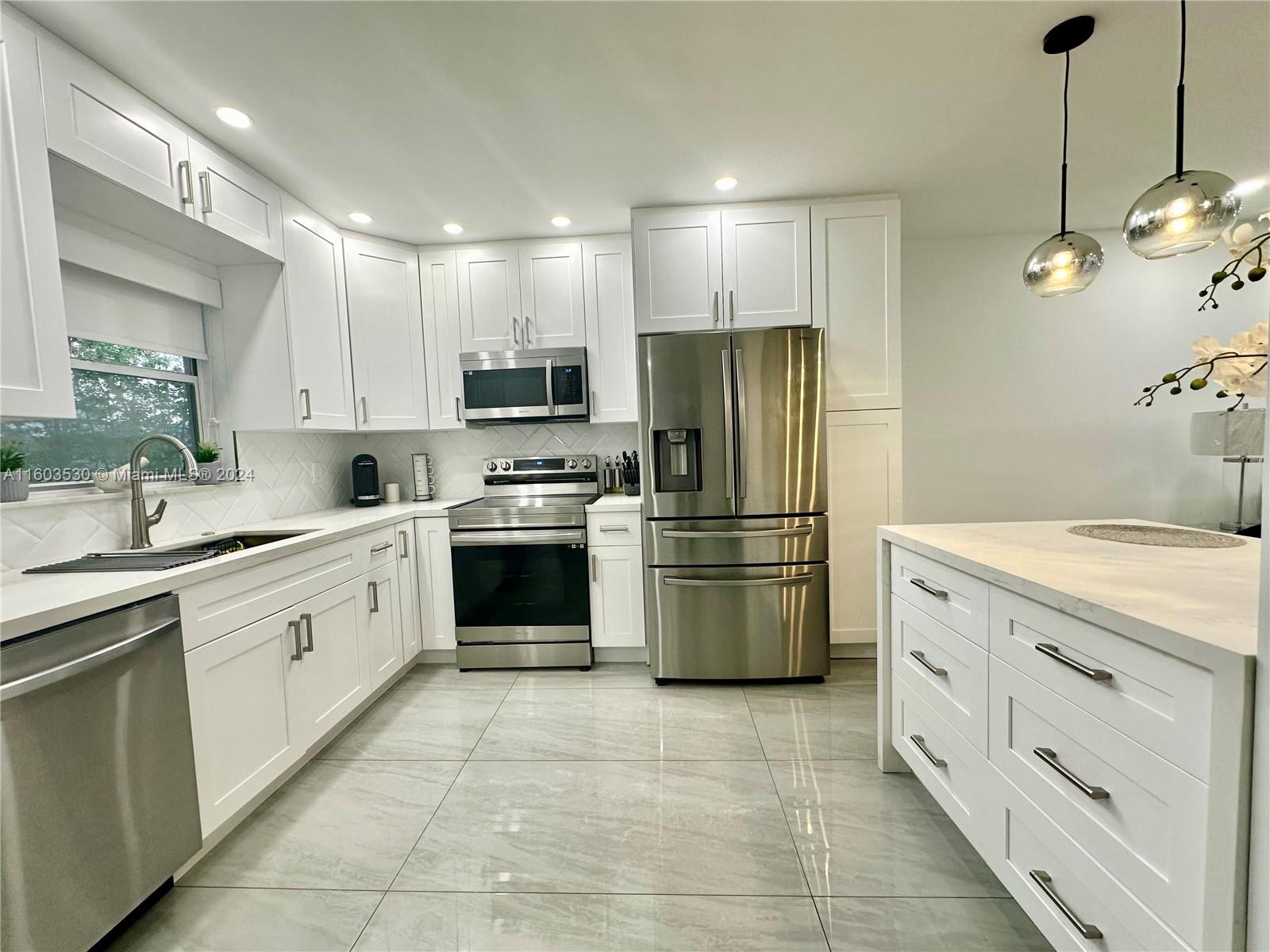 a kitchen with a refrigerator and a sink