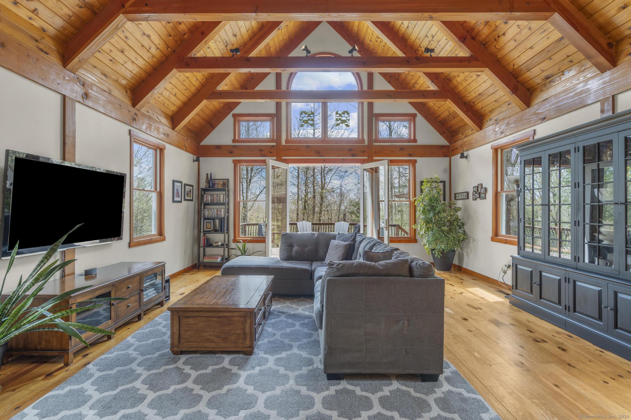 a living room with furniture tv and a large window