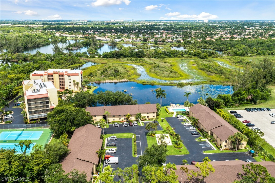 an aerial view of residential houses with outdoor space and swimming pool