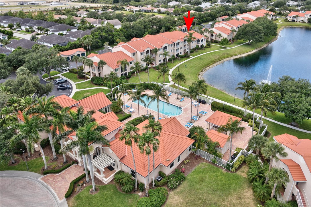 an aerial view of lake residential house with outdoor space and swimming pool