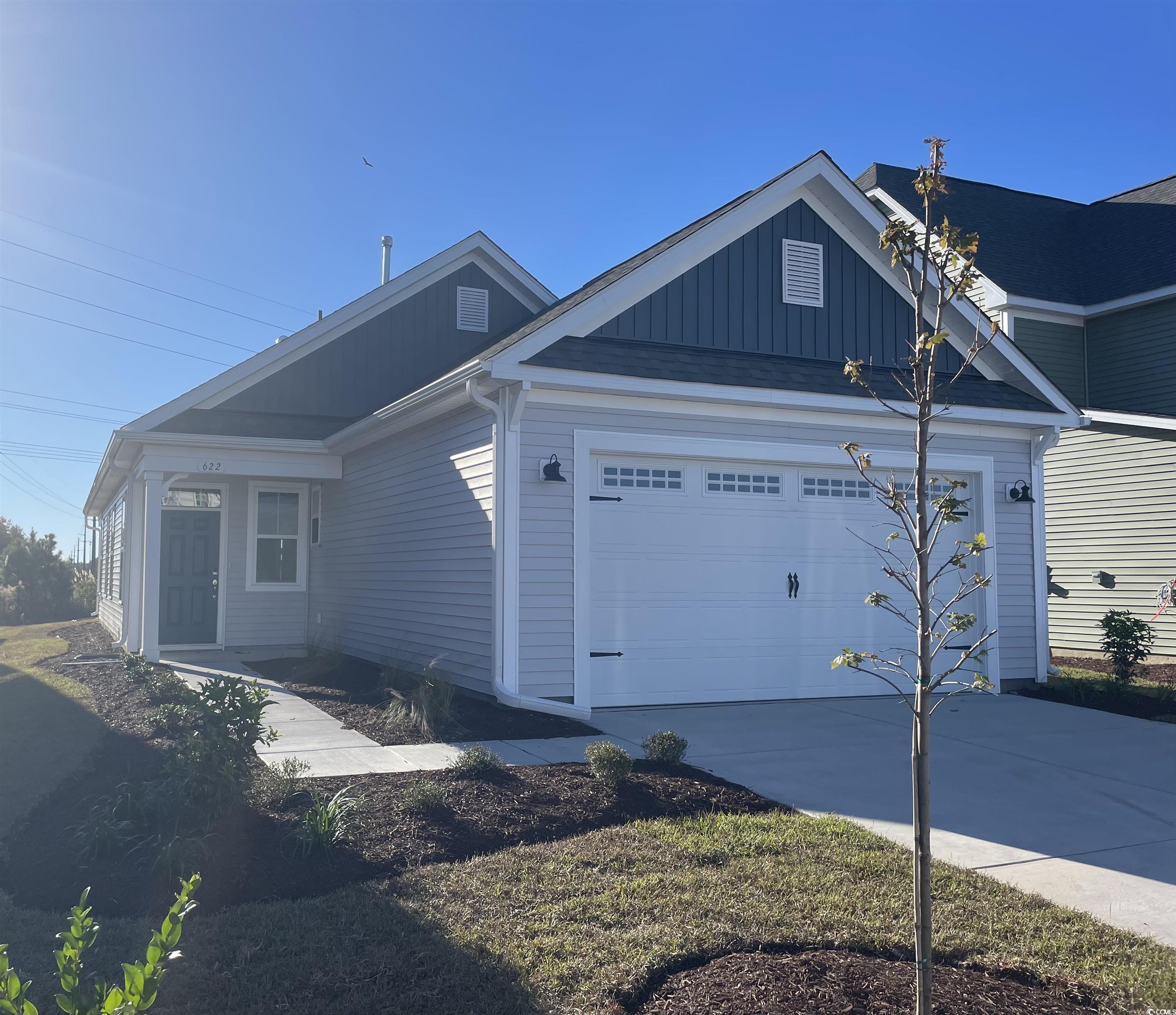 View of side of property featuring a garage