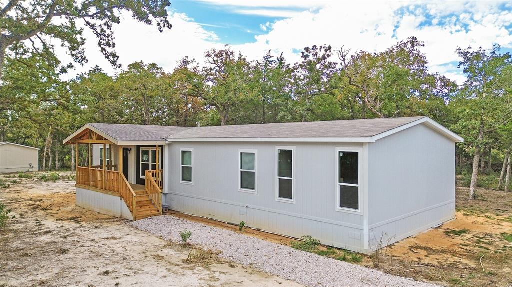 a view of a house with a backyard