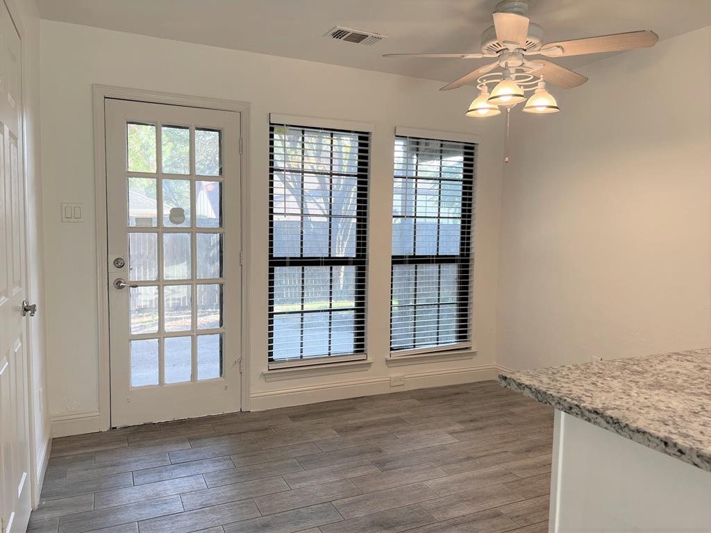 wooden floor chandelier and windows in a room