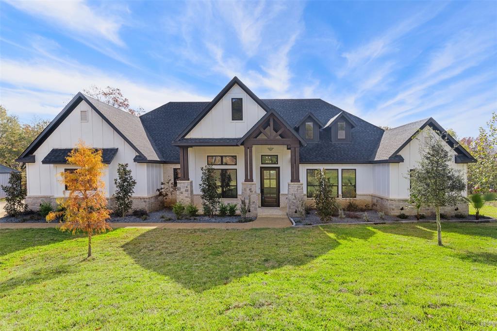 a front view of house with yard and green space