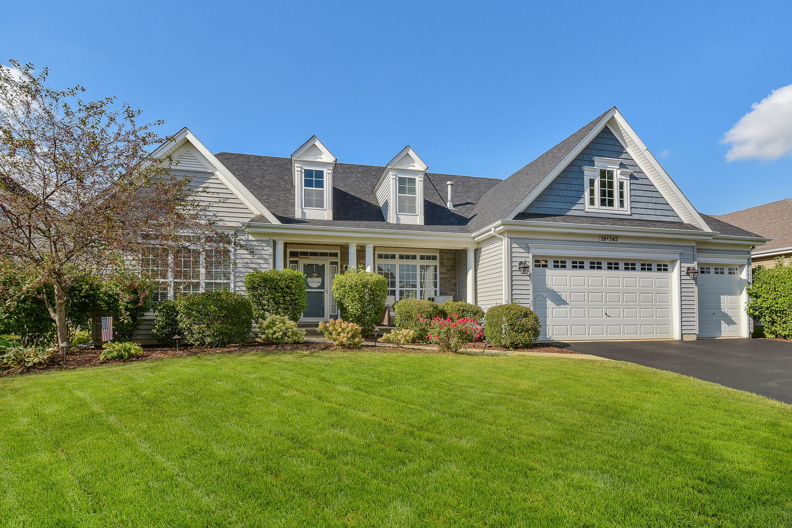 a front view of a house with a yard and garage