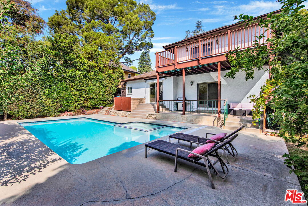 a backyard of a house with yard and outdoor seating