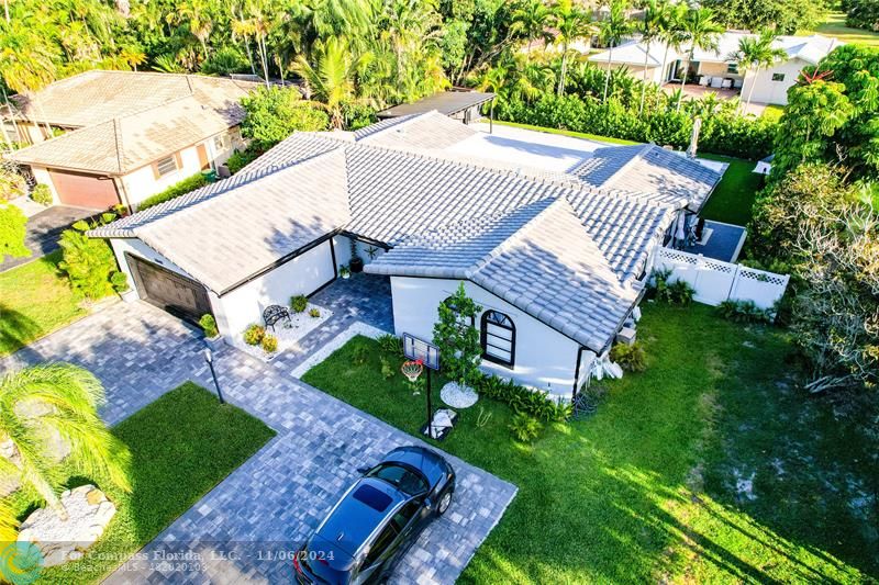 a aerial view of a house with a yard and potted plants