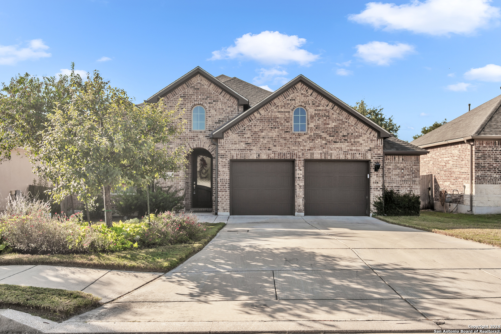 a front view of a house with a yard and garage