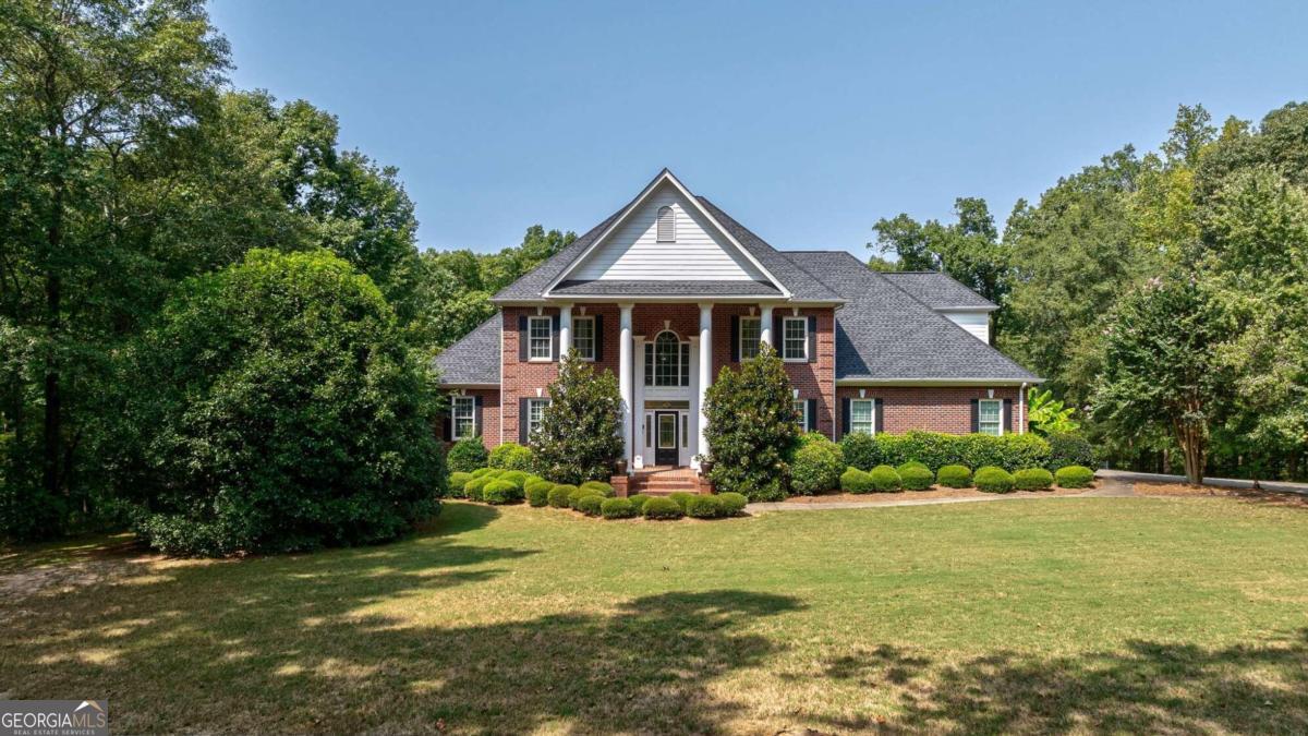 a front view of house with yard and green space