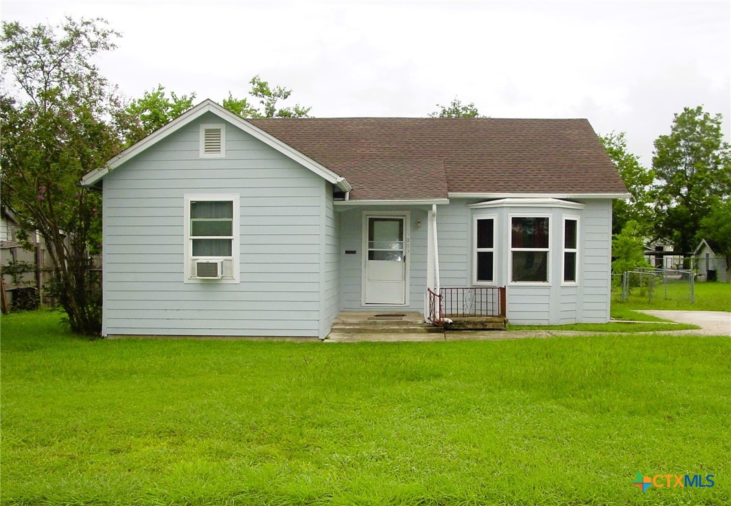 a house that has a big yard in front of it