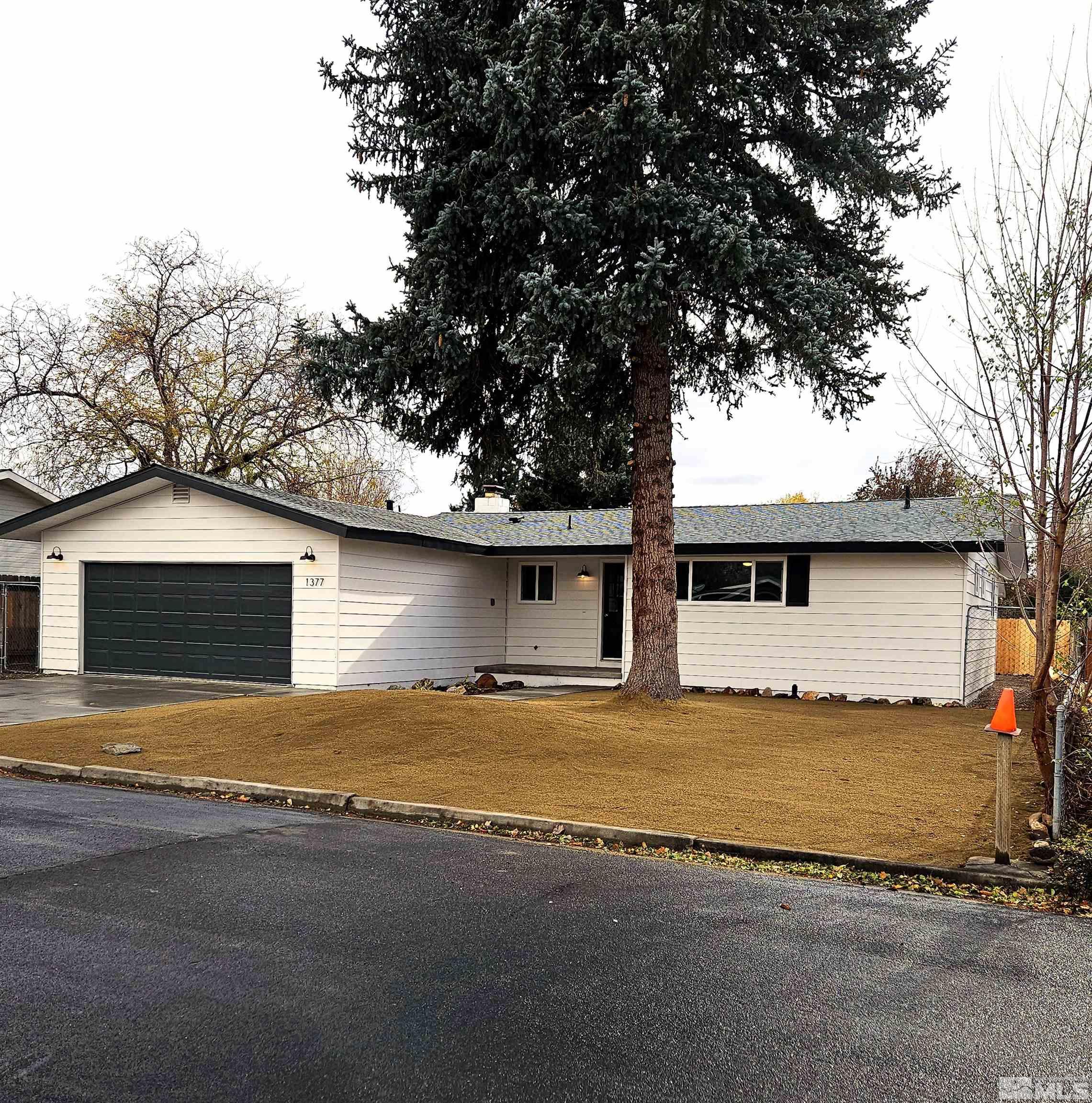 a view of a house with a yard and garage