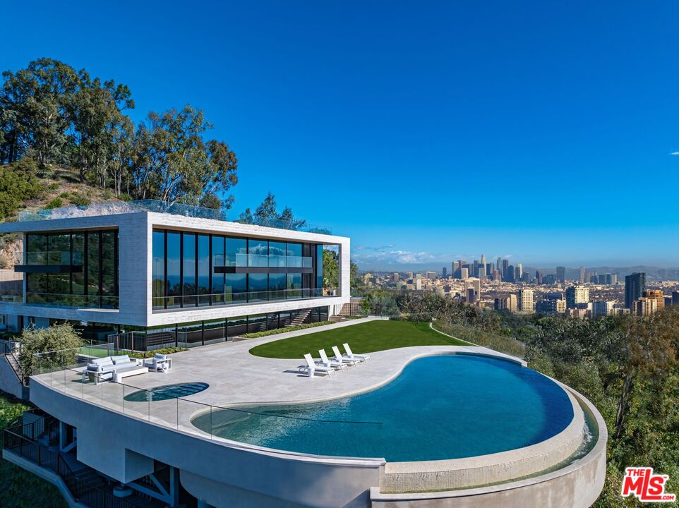 a view of house with swimming pool outdoor seating