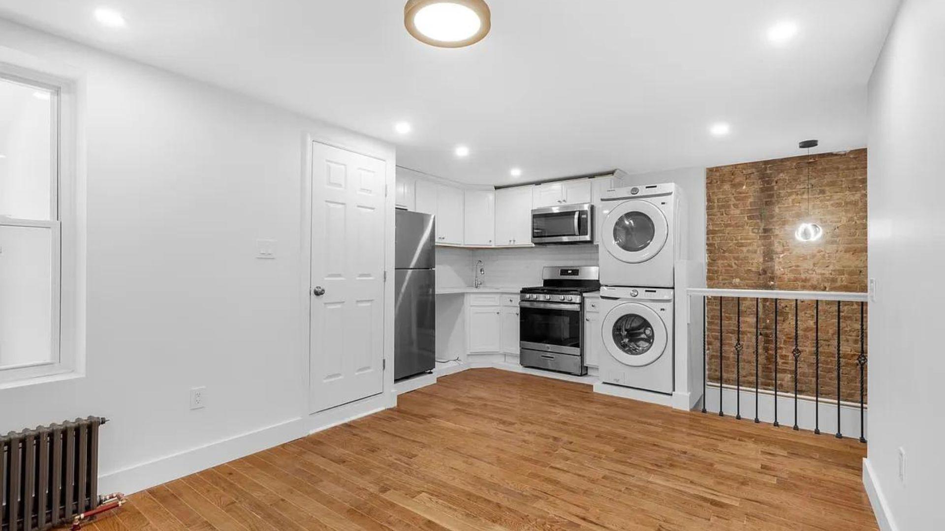 a view of a kitchen with a washer and dryer