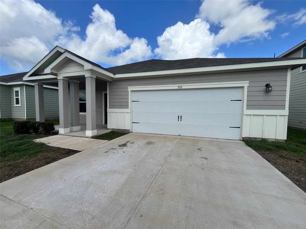 a view of a house with a yard and garage