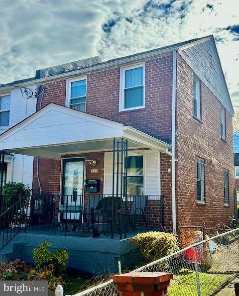 front view of a brick house with a yard