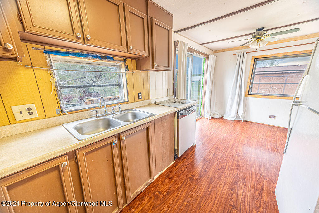 a kitchen with wooden cabinets and sink