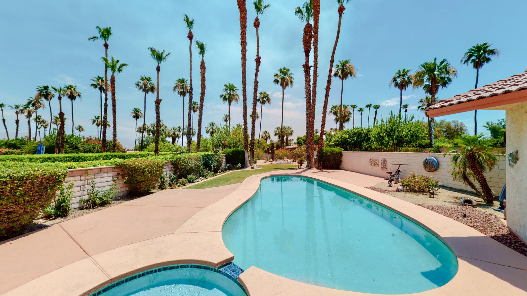 a swimming pool with outdoor seating and yard