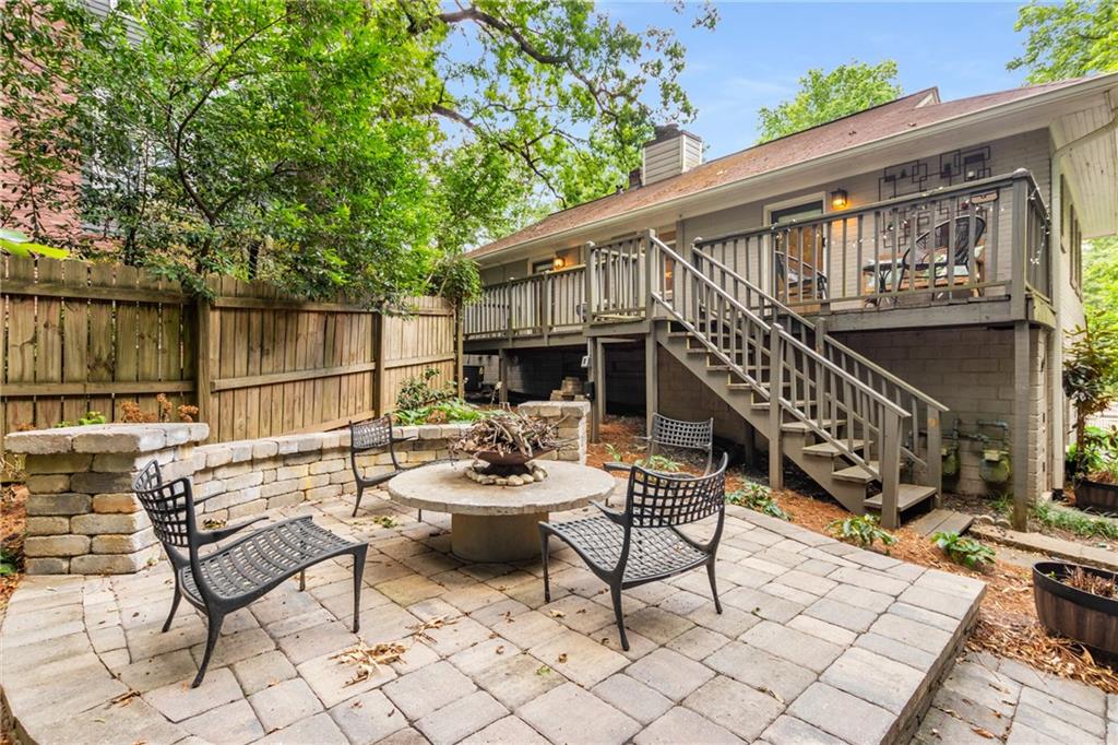 a view of a patio with a dining table and chairs with wooden floor