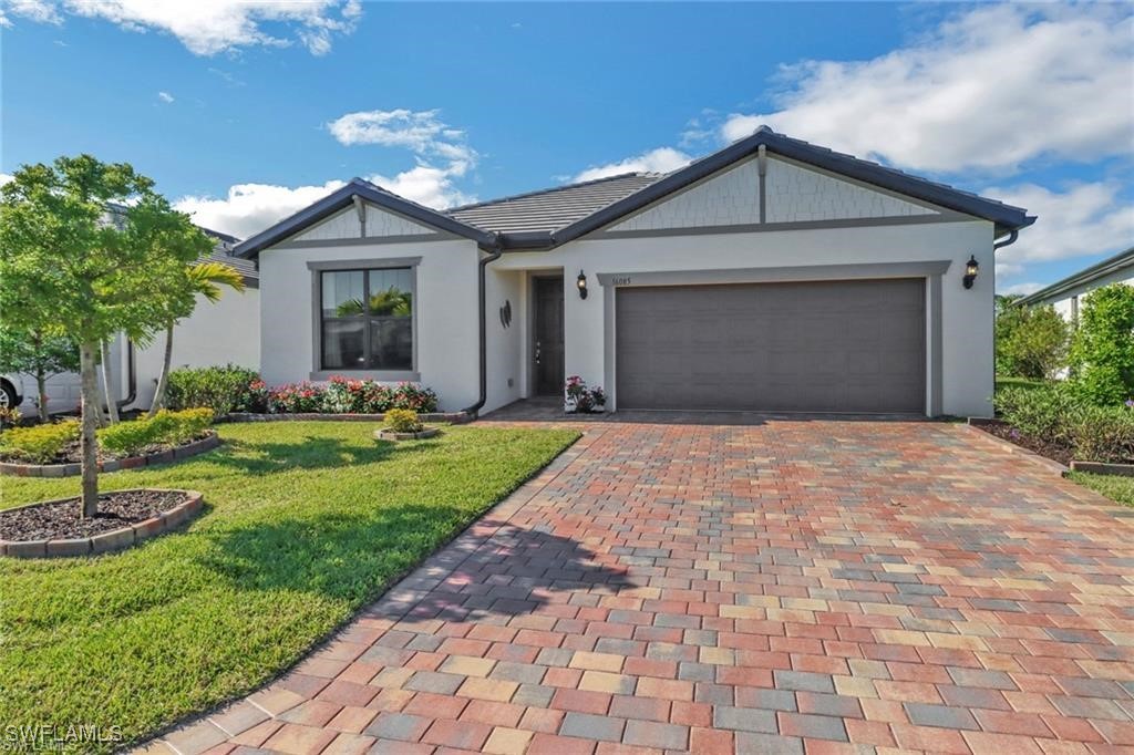 a front view of a house with a yard and garage