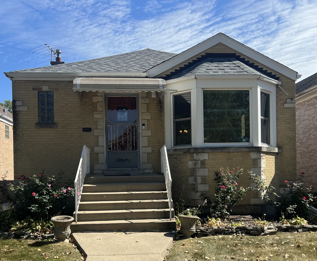 a front view of a house with plants