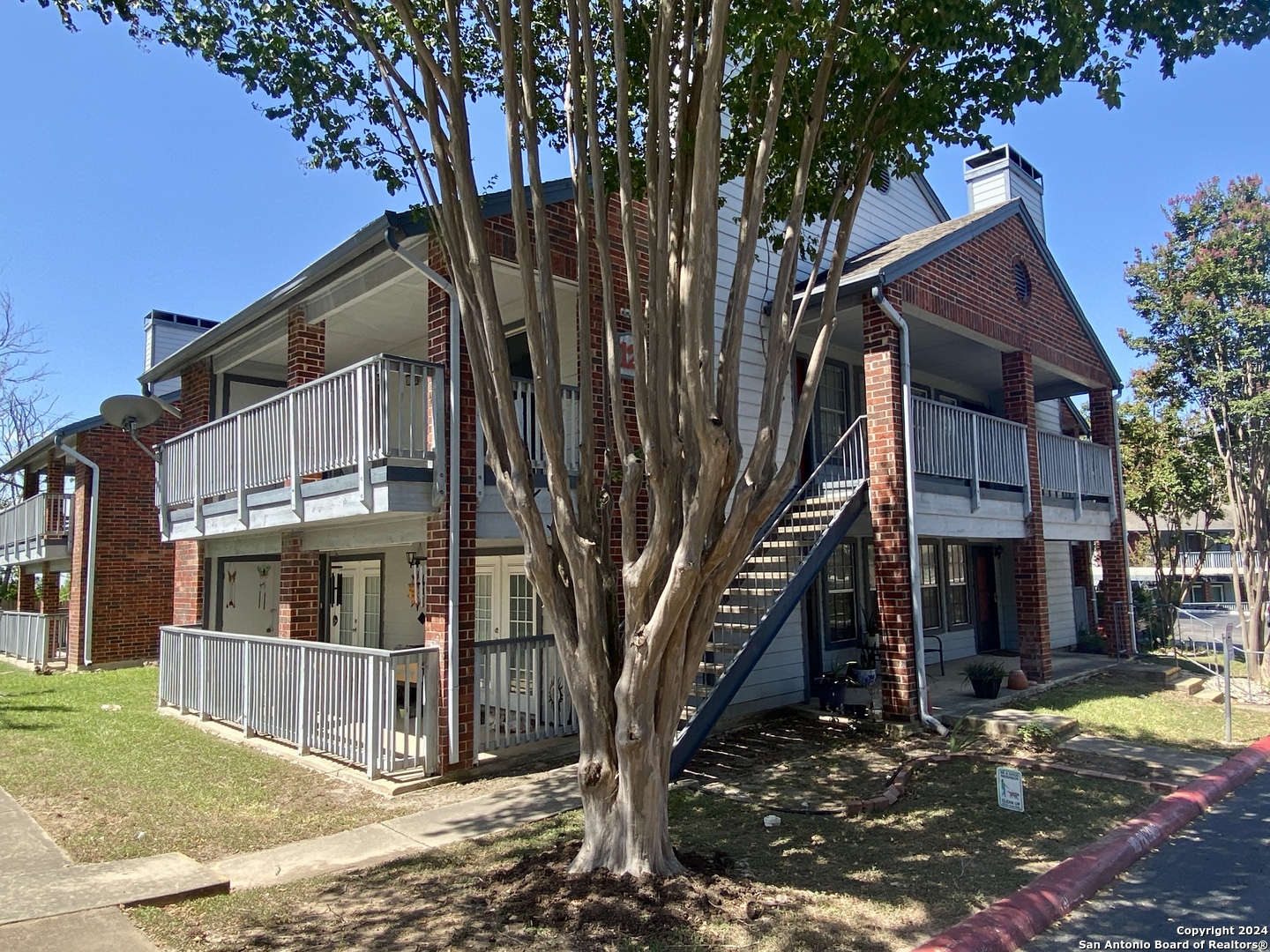 a view of a house with a tree