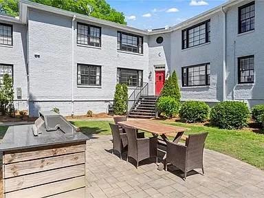 a view of backyard of house with seating space