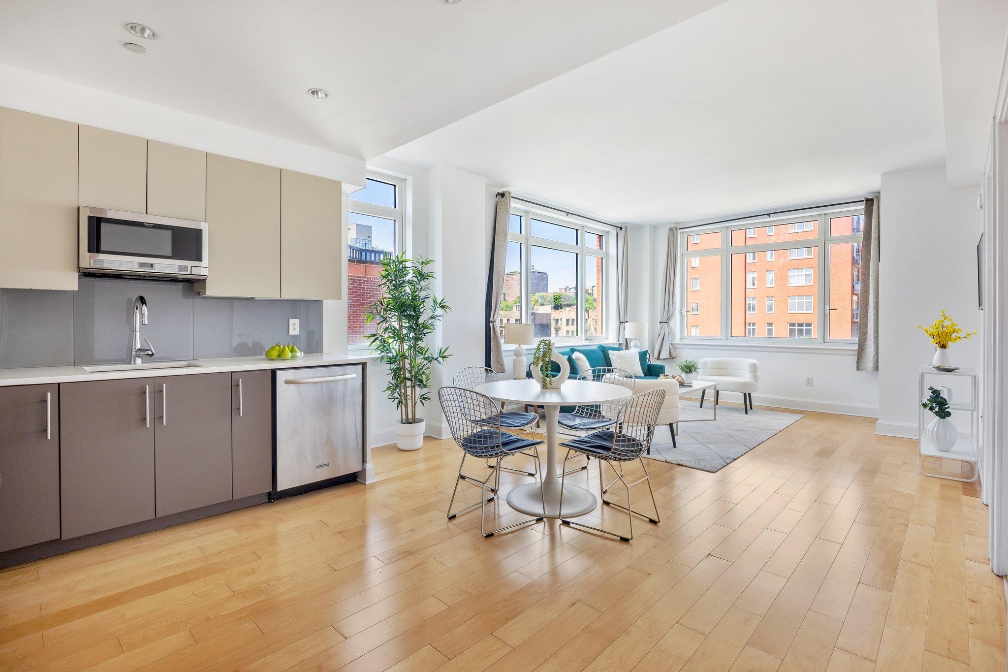 Kitchen featuring appliances with stainless steel finishes, gray cabinets, light hardwood / wood-style flooring, and sink