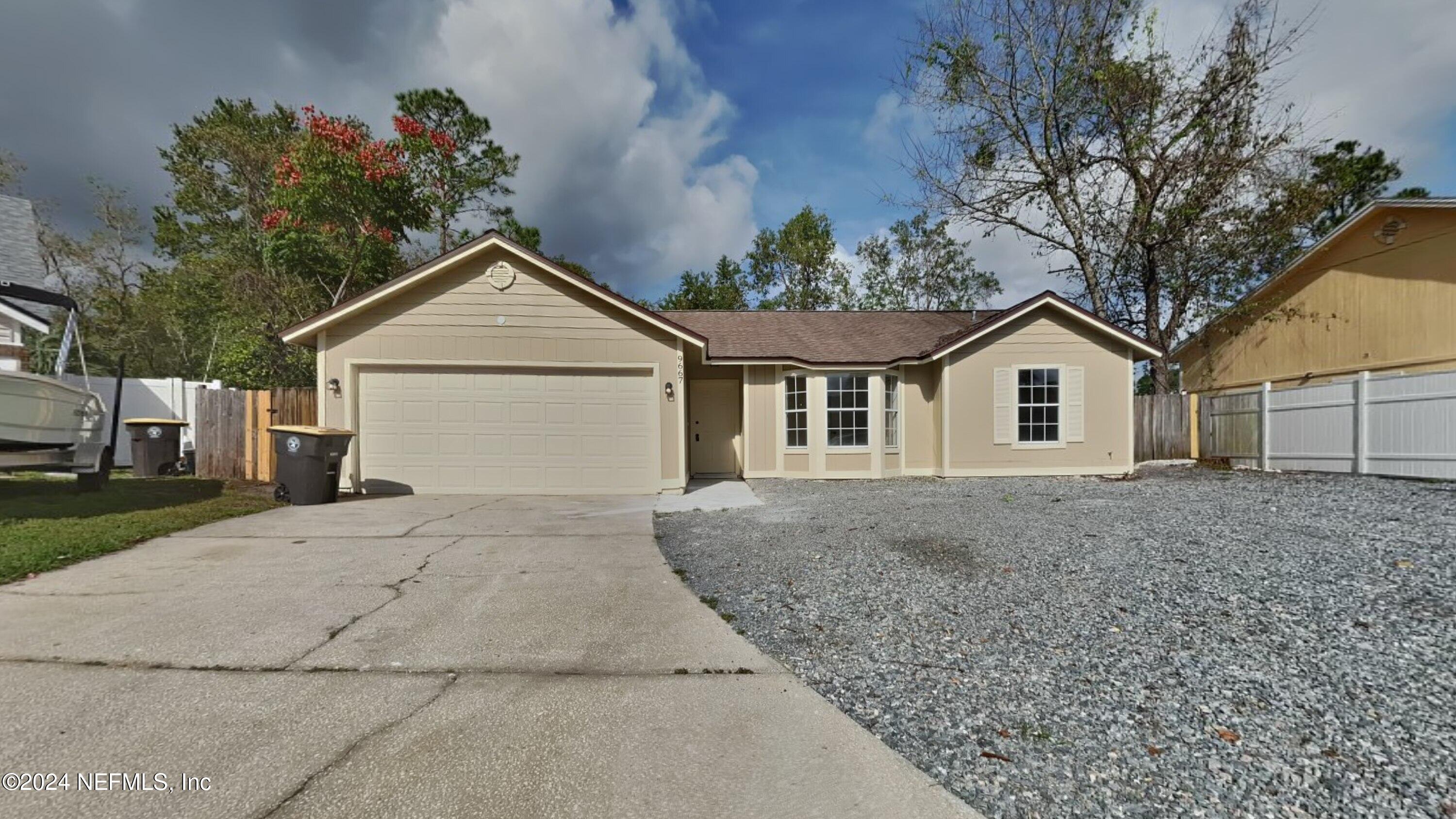 a view of a house with a yard and garage