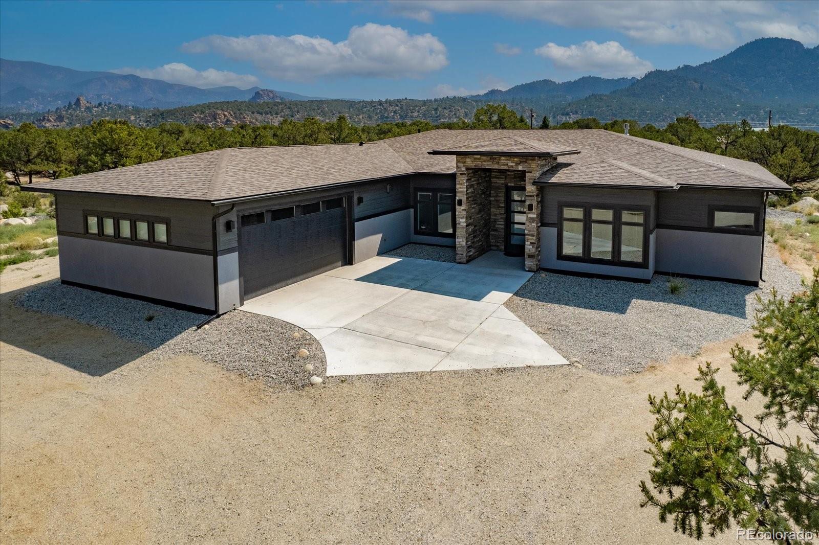 a view of a house with a terrace yard and a mountain view