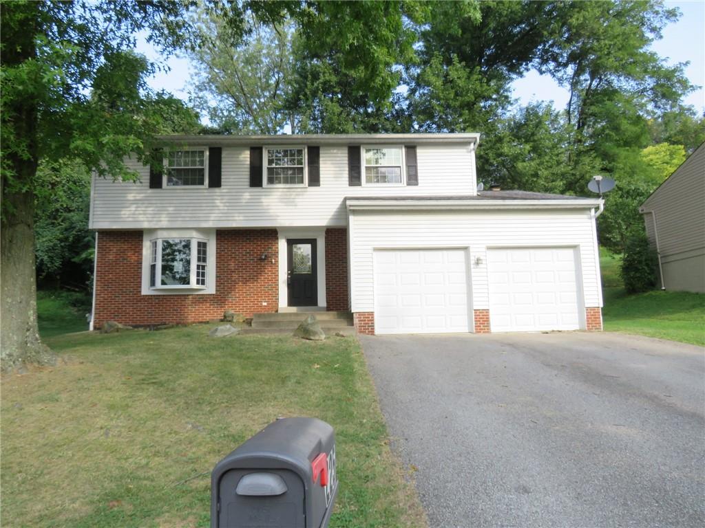 a front view of a house with garage