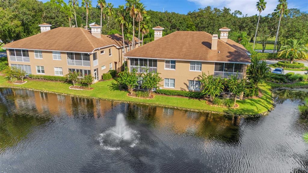 a aerial view of a house with swimming pool and a yard