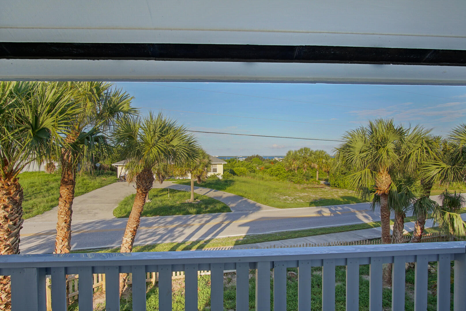 a view of a yard with wooden fence