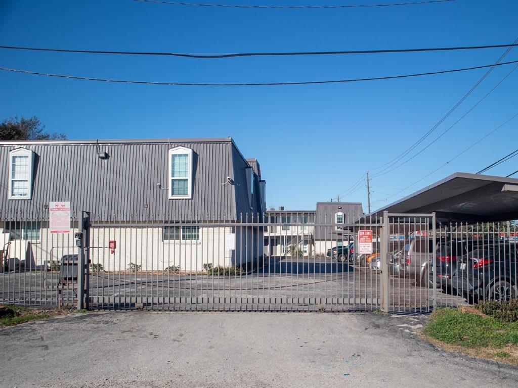 a view of a brick house with a small yard