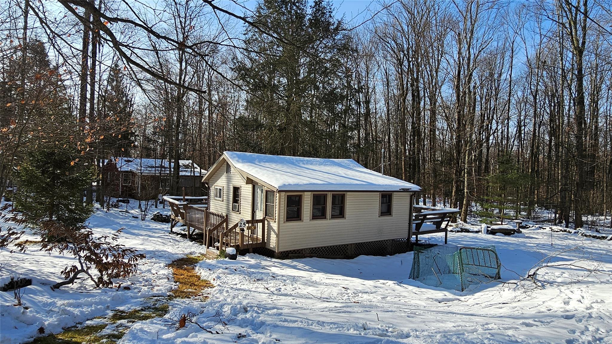 a view of a house with a yard covered with snow in the background