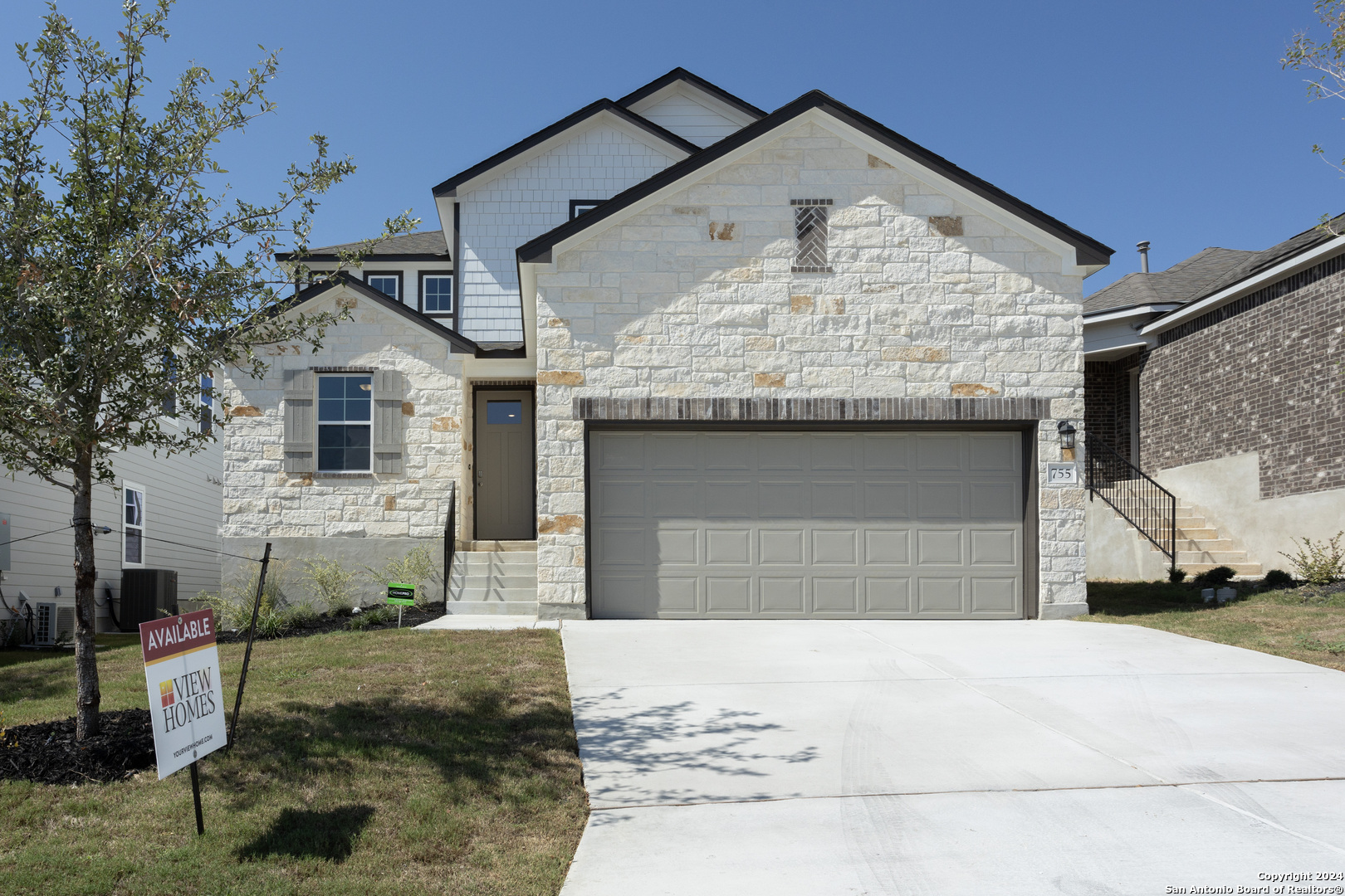 a front view of a house with a yard