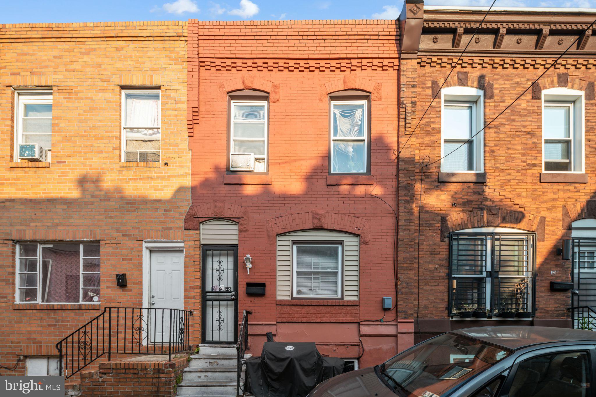 front view of a brick house with a large windows