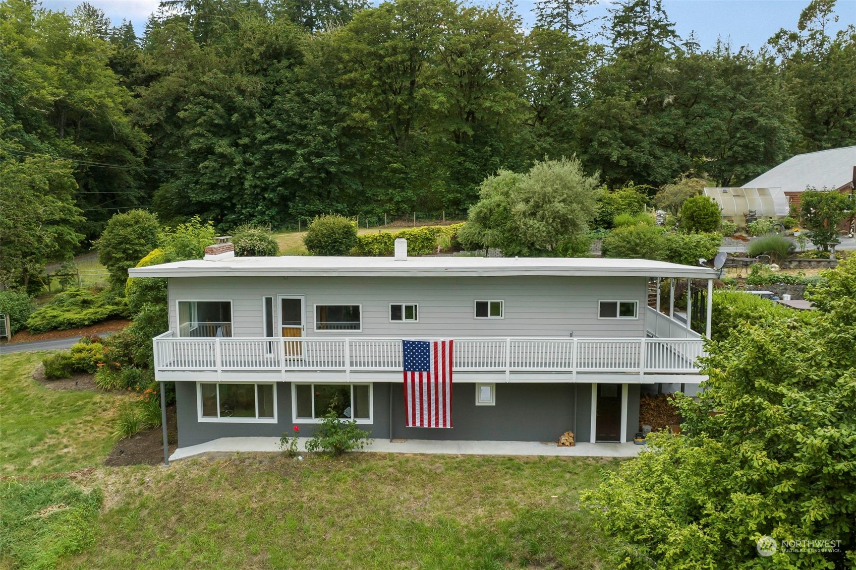 a front view of a house with a yard garage and outdoor seating