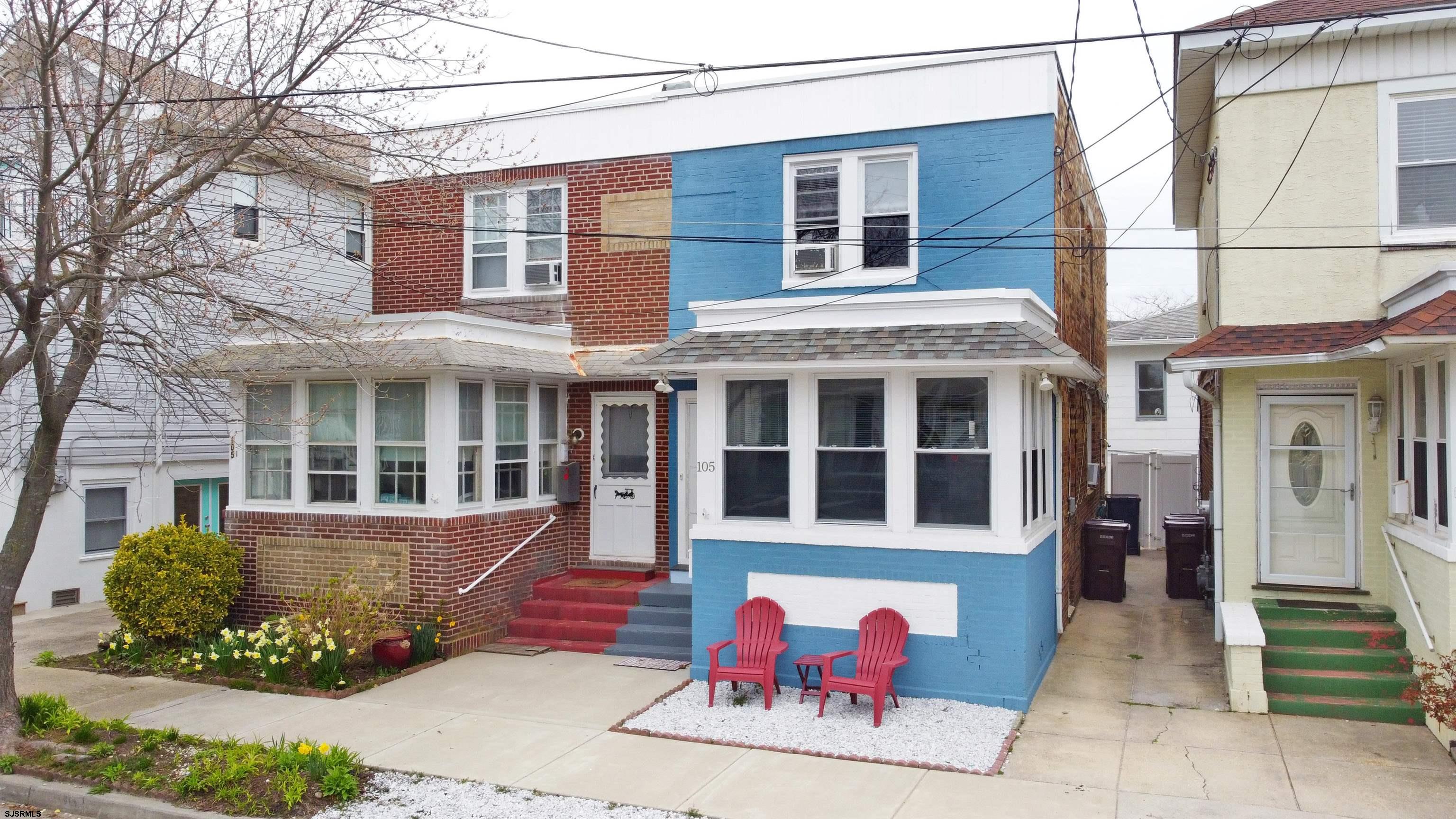 front view of a brick house with a yard