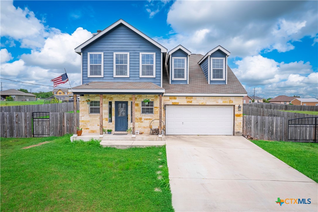 a front view of house with yard and outdoor seating