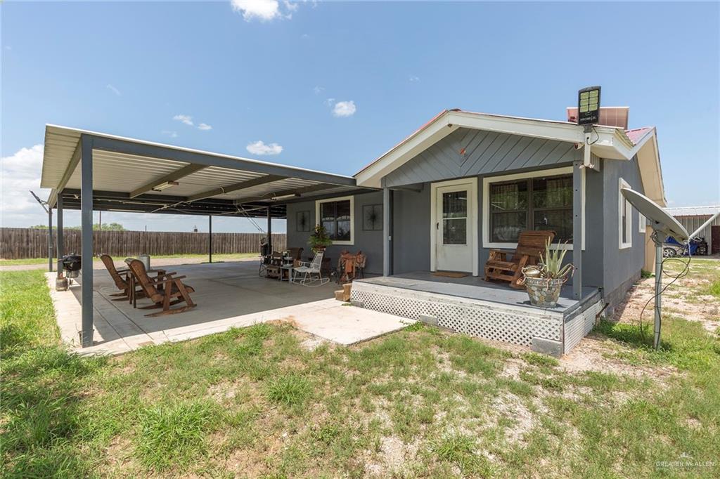 a view of a house with backyard porch and sitting area