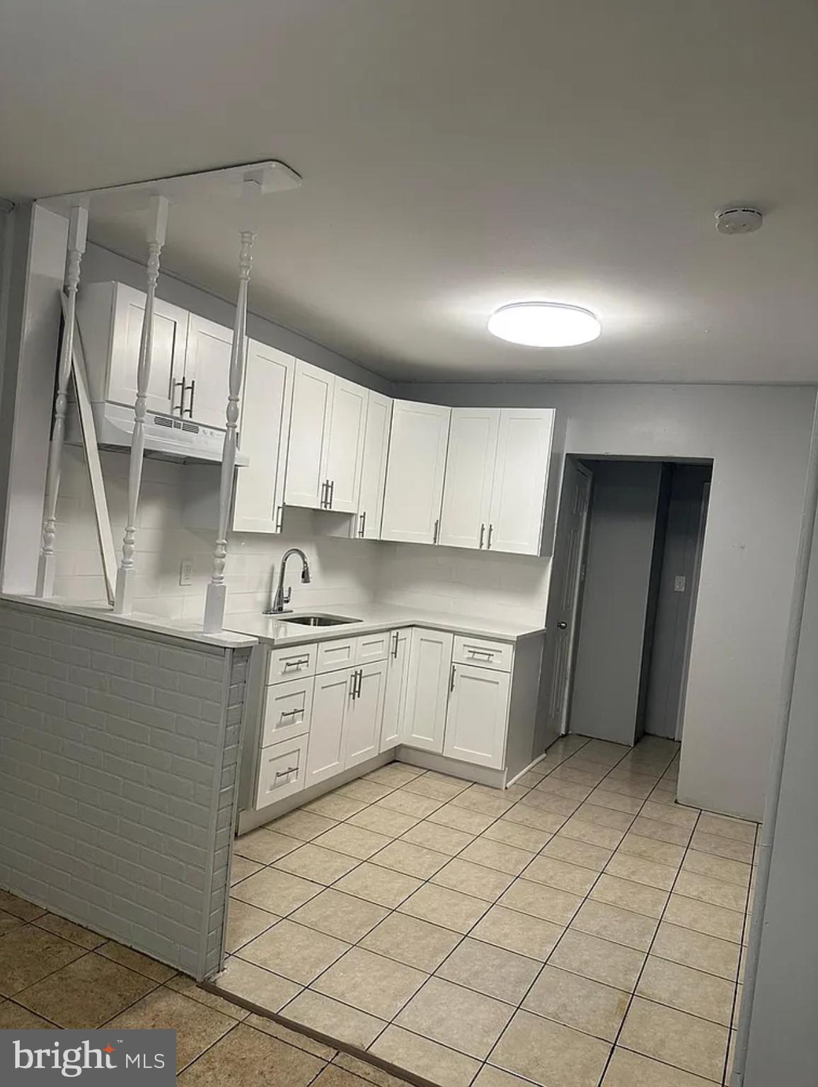 a kitchen with a cabinets and white appliances