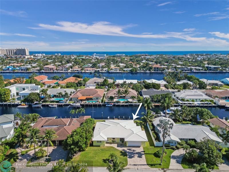 an aerial view of a city with lots of residential buildings ocean and boats